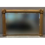 Regency style gilded wooden bevel plate over mantel mirror, having reeded columns and foliate and