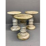 Three similar marble torchere stands, the moulded circular tops standing on a stepped circular