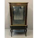 Victorian ebonised gilded and inlaid pier cabinet, the shaped top with canted angles, central glazed