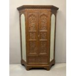 Early 20th Century ornately carved oak double door break front wardrobe, the moulded cornice above