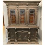 Late 19th/early 20th Century carved oak Flemish design two stage bookcase, the moulded cornice above