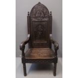 Large dark oak arched backed throne chair overall with figural and foliate carving, foliate scrolled