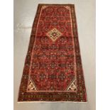 Persian Hamadan runner with central medallion and stylised multicolored floral and foliate