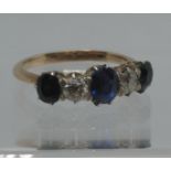 A sapphire and diamond four stone ring set in white metal with a yellow metal band. Ring size K.