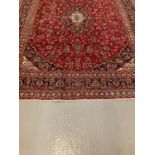 Large red ground Persian Kashan carpet with traditional Kashan medallion design, flowers and foliage