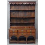 19th Century oak two stage rack back pot board dresser, the moulded cornice above carved frieze with