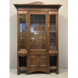 In the style of Liberty & Co, London, Arts and Crafts design oak bookcase cabinet, the moulded and