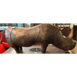 Leather novelty footstool in the form of a rhino, probably retailed by Liberty's. Unmarked. 110cm