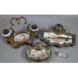 Two similar champleve enamel and gilt metal single desk inkwells, both having porcelain panels of