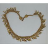 A yellow metal fringe necklace. Approx weight 42.6 grams. (B.P. 21% + VAT)