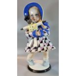 Large Art Deco Lenci ceramic figure, modelled as a girl wearing a bonnet hat with chequered dress,