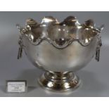 Early 20th Century small silver Monteith pedestal bowl with lion mask ring handles and circular base