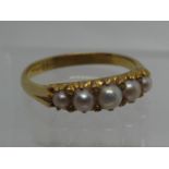 A five stone pearl ring set in yellow metal. Ring size P&1/2. Approx weight 3.1 grams. (B.P. 21% +