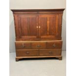 Early 19th Century Welsh oak low two stage press cupboard, the moulded top above two blind