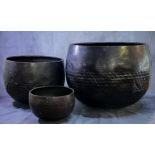 Three Japanese patinated bronze Resting bells with repoussé beaten decoration, the largest with