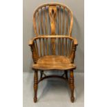 19th Century elm and ash Windsor wheel back chair or armchair on a moulded seat with turned legs and