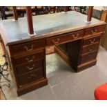 Edwardian mahogany knee hole desk, the leather top above two pedestals with a bank of three drawers.