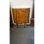 Early 20th century walnut bow front cabinet having three drawers and standing paw feet. (B.P.