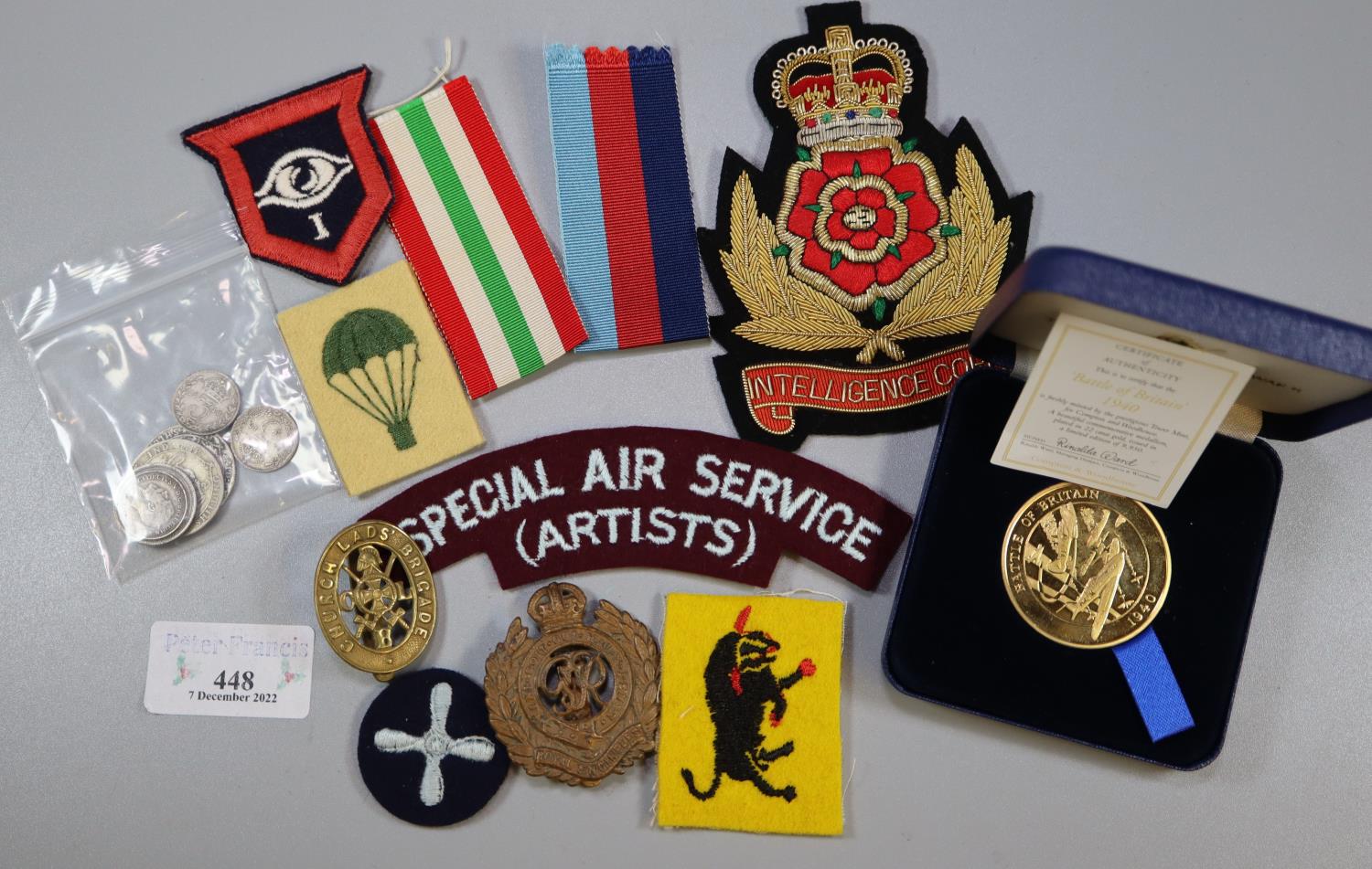 Plastic box of GB silver coins and military items, to include: boxed medallions, uniform patches,