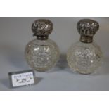 Two similar globular hobnail cut glass scent bottles with silver tops. (2) (B.P. 21% + VAT)