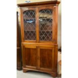 19th century mahogany two stage corner cabinet, the moulded cornice above two lead glazed doors,