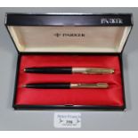 Cased pair of Parker propelling pencil and cartridge fountain pen with gold plated caps. (2) (B.P.