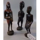 Group of hand carved, probably African small statues, comprising: two male warriors and one