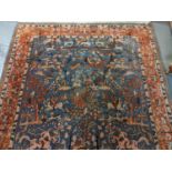 Chinese Persian style blue ground rug, overall decorated with animals, birds and hunting scenes,