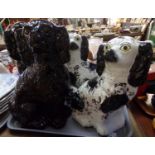 Two pairs of Staffordshire dogs, one black with gilt highlights, the other black and white with