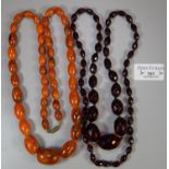 A string of faceted prismatic red beads and a graduated string of orange beads. (2) (B.P. 21% + VAT)