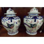 Pair of modern decorative vases and covers, having elephant heads, the body with exotic birds