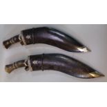 Two similar Nepalese Kukri with hardwood handles, leather scabbards and miniature knives, both