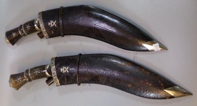 Two similar Nepalese Kukri with hardwood handles, leather scabbards and miniature knives, both