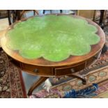 Mahogany inlaid revolving drum table having shaped leather inset top above an arrangement of drawers