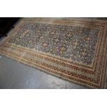 Middle Eastern design blue ground carpet having central stylised floral and foliate panels with