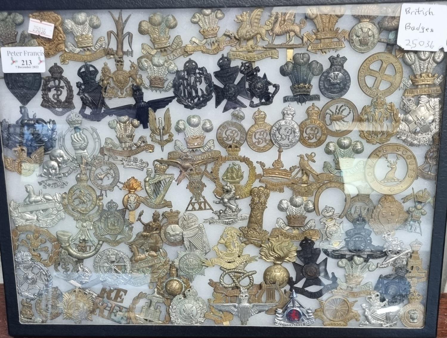 Display case of British cap badges, to include: Fishguard, The Leinster, Royal Lance etc. (B.P.