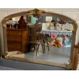 Modern over mantle mirror, the frame in silver and gold finish with scroll and shell motifs. (B.P.