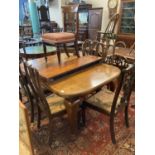 Early 20th century mahogany extending dining table with two additional leaves and a collection of