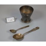 Two silver commemorative spoons, one marked 'Here We Rest', together with a white metal beaker. (B.