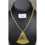 Archaic design triangular yellow metal pendant, marked 18K on an 18ct gold snake chain. Total weight