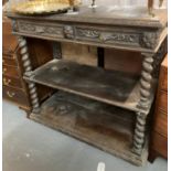 Late Victorian carved oak buffet, the two drawers with carved lion masks standing on barley twist