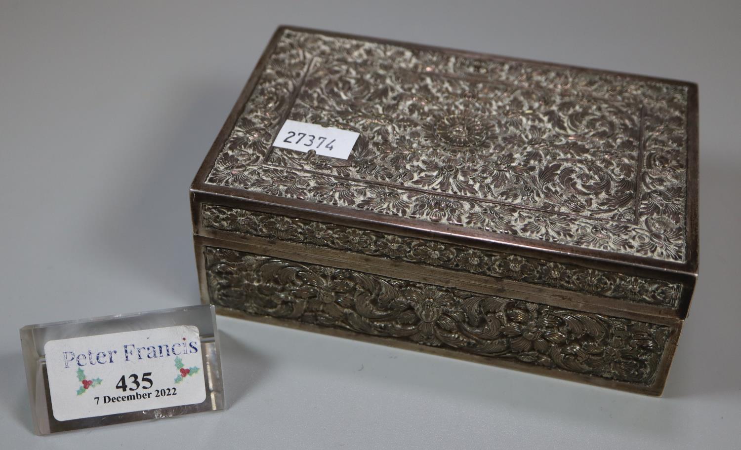 Indian silver rectangular shaped repousse decorated cigarette box with hinged cover. 9.4 troy ozs