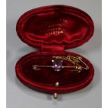 Edwardian bar brooch set with an amethyst in fitted box. (B.P. 21% + VAT)