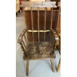 Primitive design stickback armchair on three legs, carved to the back 'Hafod'. (B.P. 21% + VAT)