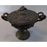 White metal two handle lidded vessel, overall with relief moulded decoration of vines and