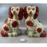 Two similar Staffordshire style pottery fireside Spaniels with painted features. (B.P. 21% + VAT)