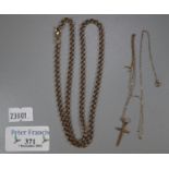 Gold curb link neck chain and gold crucifix on fine link chain. 14.8g approx. (B.P. 21% + VAT)