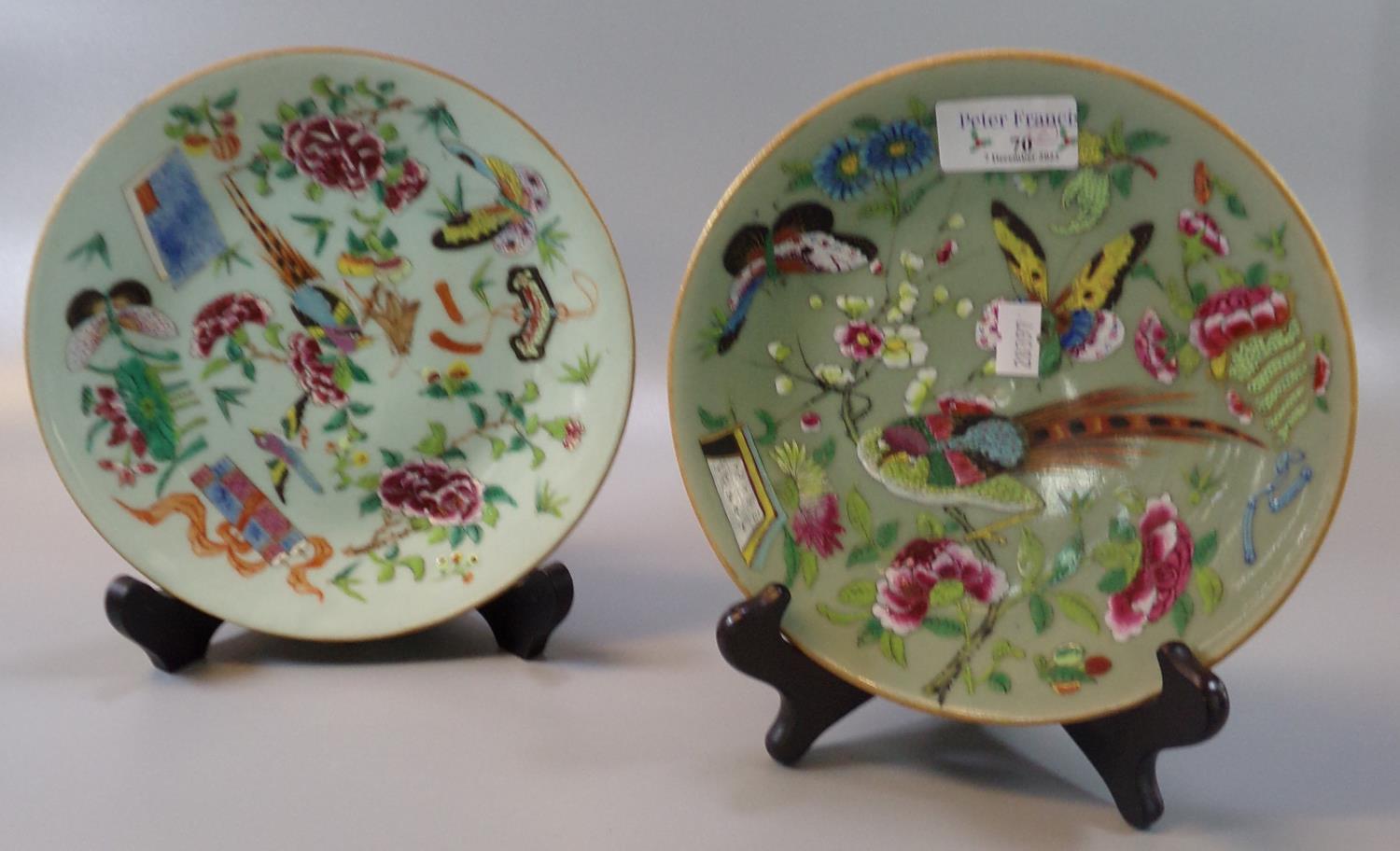 Two similar Chinese porcelain Famille rose dishes on a celadon glaze decorated with birds,