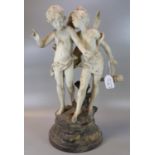 Faux marble figure group of two winged angels or cherubs, on naturalistic base. (B.P. 21% + VAT)