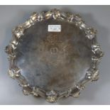 19th century silver pie crust salver, the border decorated with shells standing on three ball and